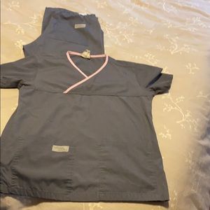 Urbane scrubs, gray with light pink trim.